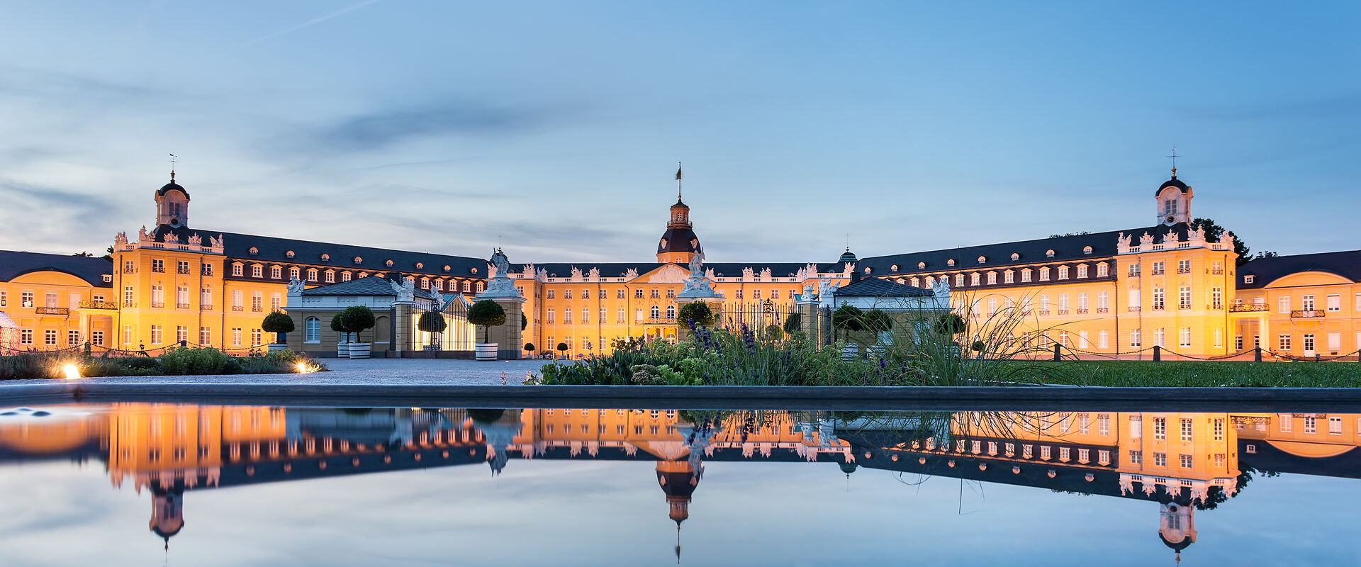 Karlsruhe castle reflected in water in summer evening