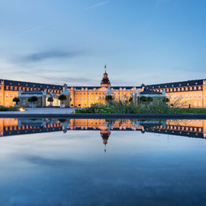 Karlsruhe castle reflected in water in summer evening