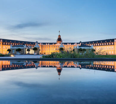 Karlsruhe castle reflected in water in summer evening